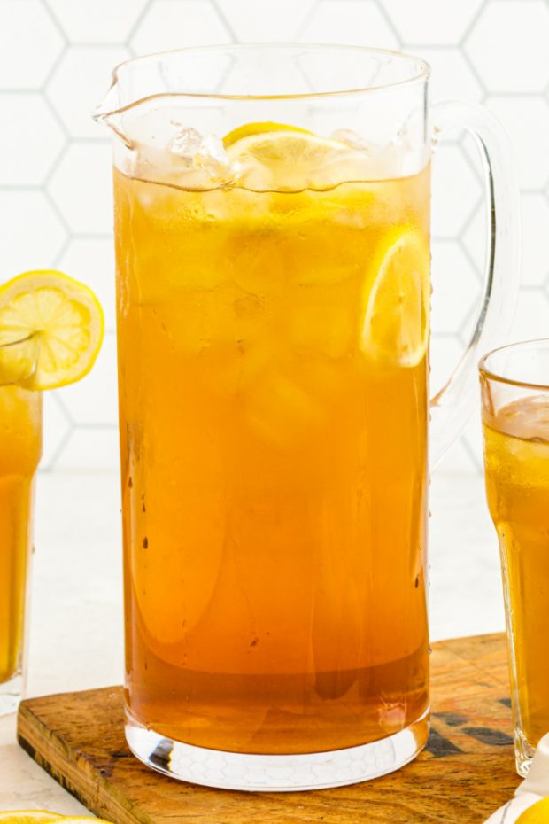 a pitcher of Iced Tea with ice and slices of lemon