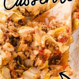 close up shot of Cabbage Roll Casserole in a clear casserole dish with a wooden spoon