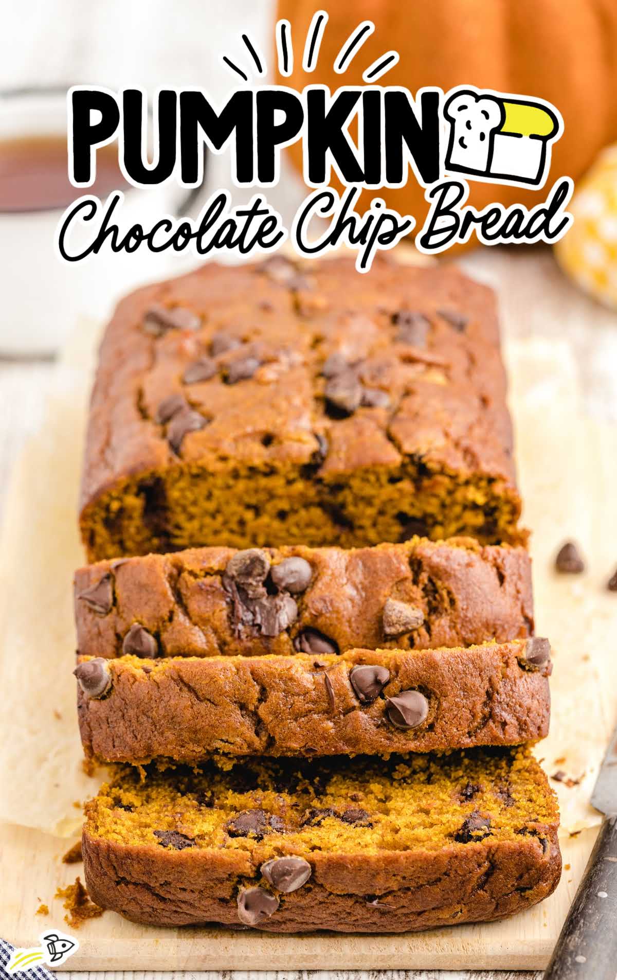 Pumpkin chocolate chip bread loaf sliced with chocolate chips scattered throughout.