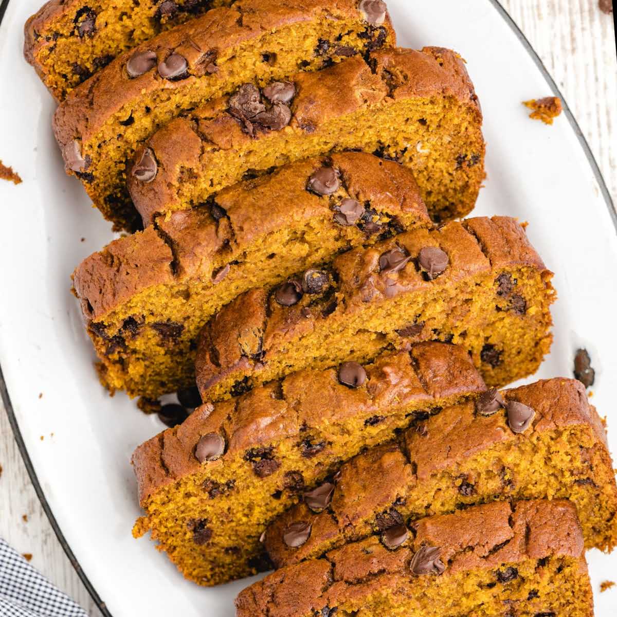 Overhead view of sliced pumpkin chocolate chip bread arranged on a plate.