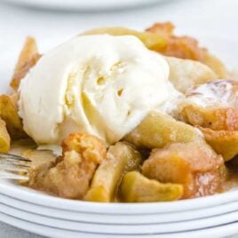 close up shot of Apple Betty topped with ice cream