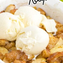 close up shot of grandma's apple betty in a white casserole pan with a 3 scoops of ice cream on the top