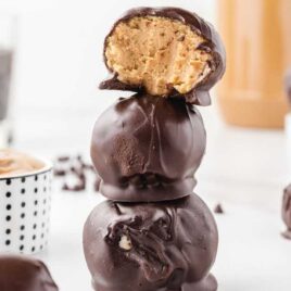 close up shot of chocolate dipped Peanut Butter Balls stacked on top of each other