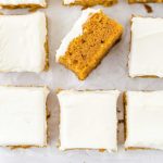 close up overhead shot of pumpkin bars topped with cream cheese frosting