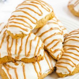 close up shot of Starbucks Copycat Pumpkin Scones piled on top each other on a white plate
