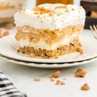 slice of butterscotch delight on a white plate showing the 4 layers