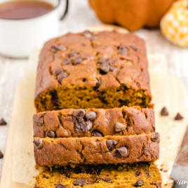 close up shot of chocolate chip pumpkin bread cut into slices on a wooden board