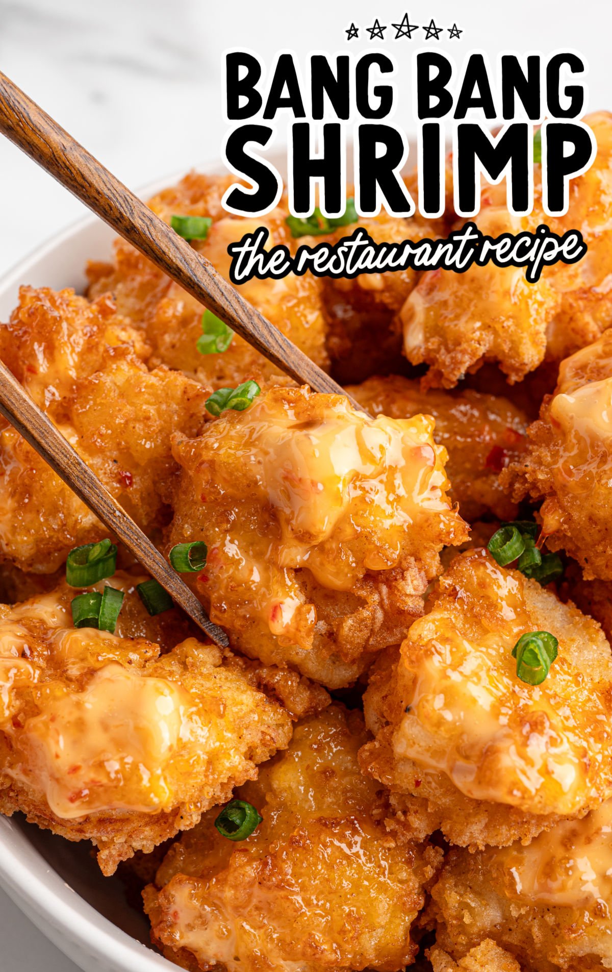 Crispy fried bang bang shrimp coated with a creamy sweet-spicy sauce, served restaurant-style in a bowl.