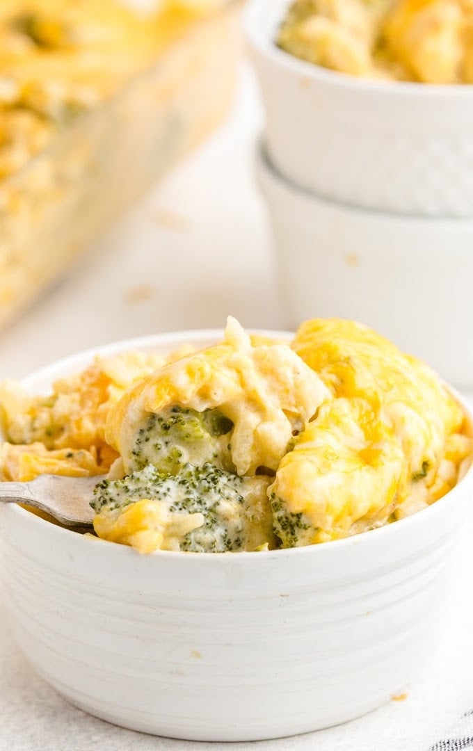 close up shot of broccoli and rice casserole in a white bowl