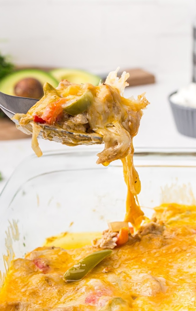 close up shot of chicken fajita casserole on a large spoon