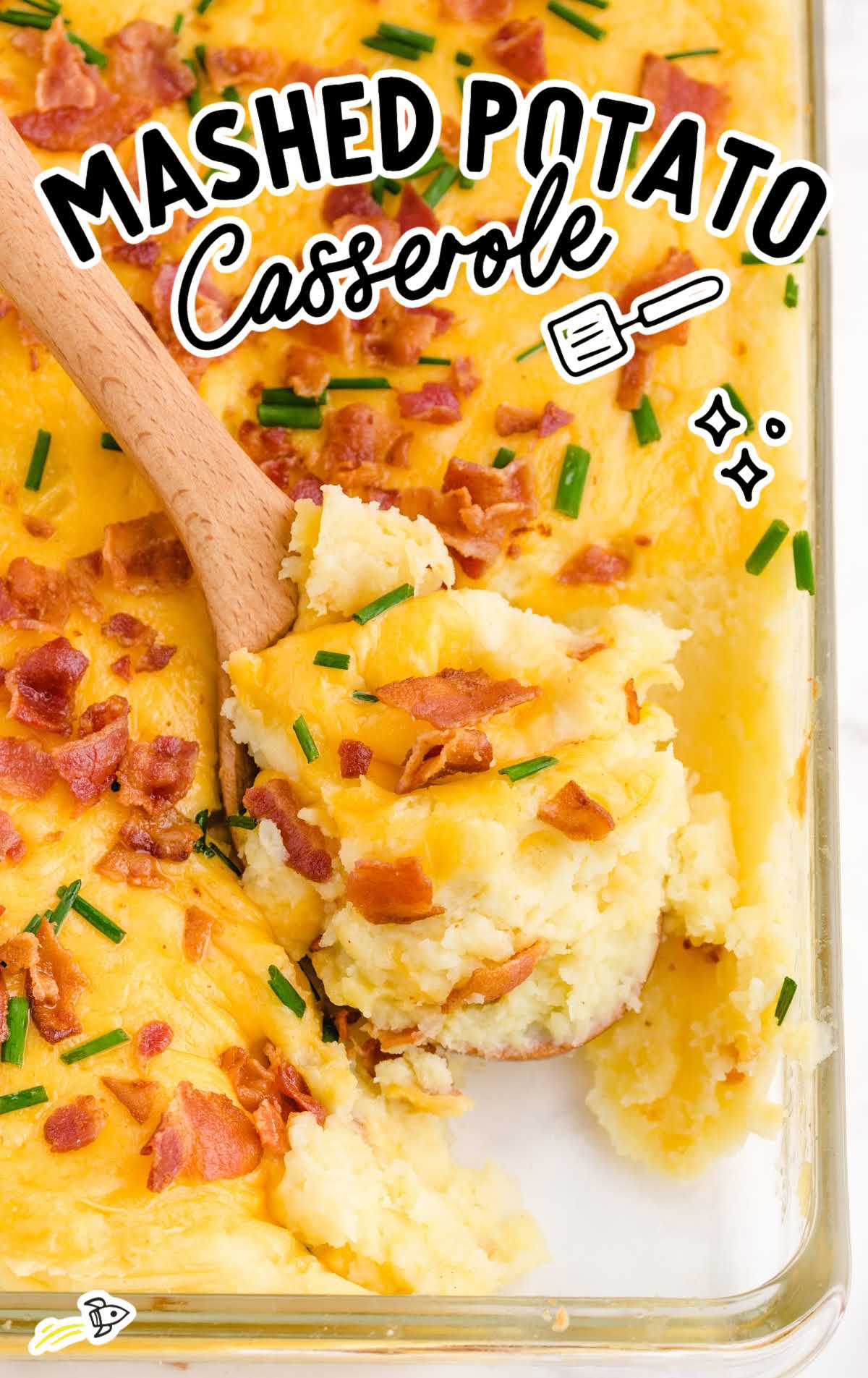 close-up shot of mashed potato casserole with bacon bits on the top in a clear pan