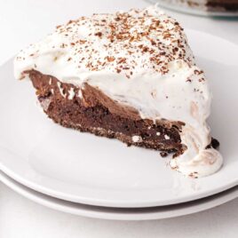 close up shot of a slice of Mississippi Mud Pie garnished with chocolate shavings on a plate