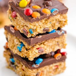 close up shot of No Bake Monster Cookies stacked on top of each other on a plate