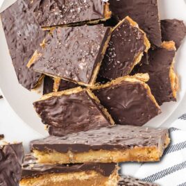 close up overhead shot of Ritz Cracker Toffee piled on a plate and Ritz Cracker Toffee stacked on top of each other