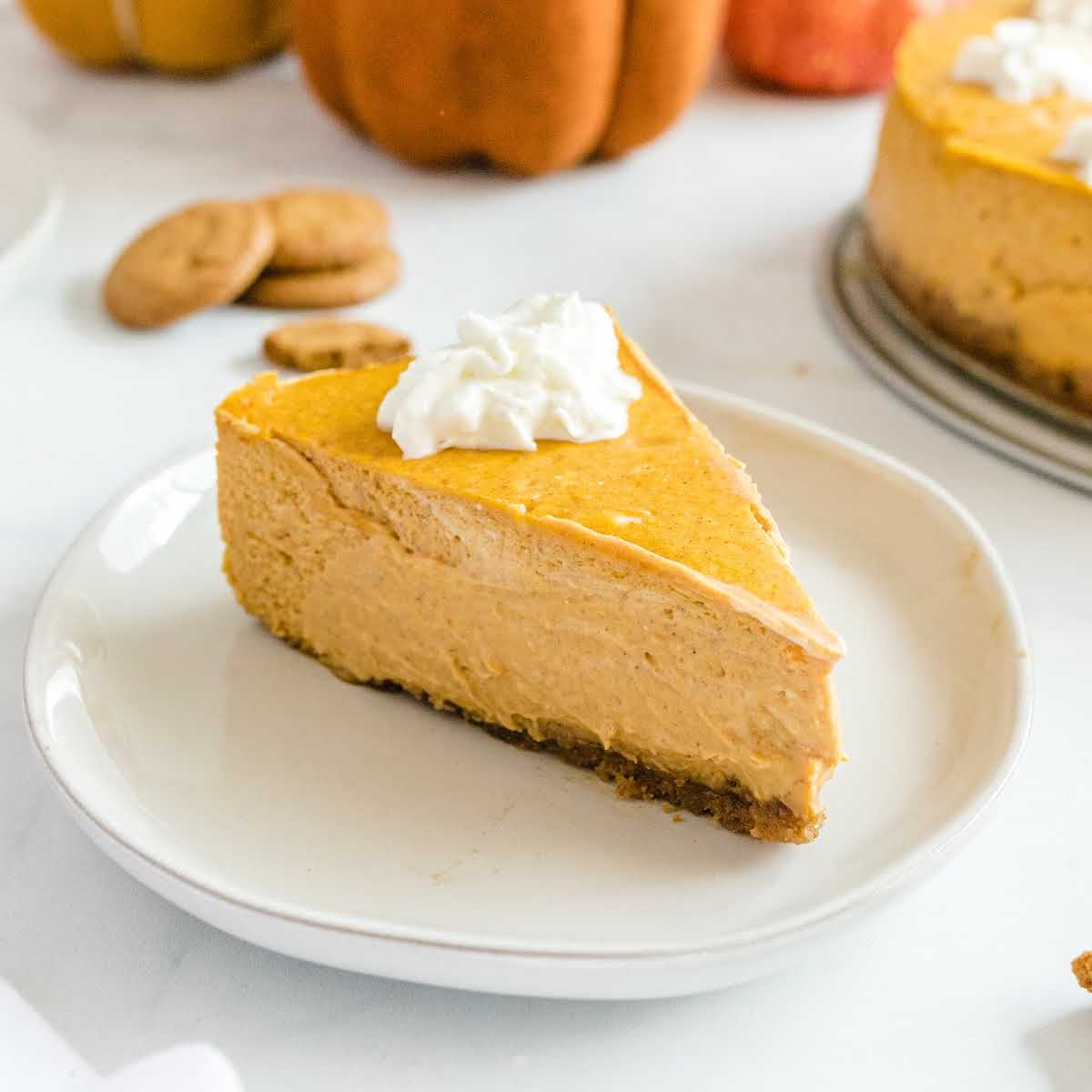 Pumpkin cheesecake recipe card with ingredients and instructions displayed visually with image.