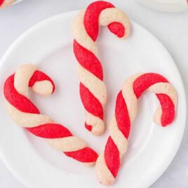candy cane cookies on a white plate and surface