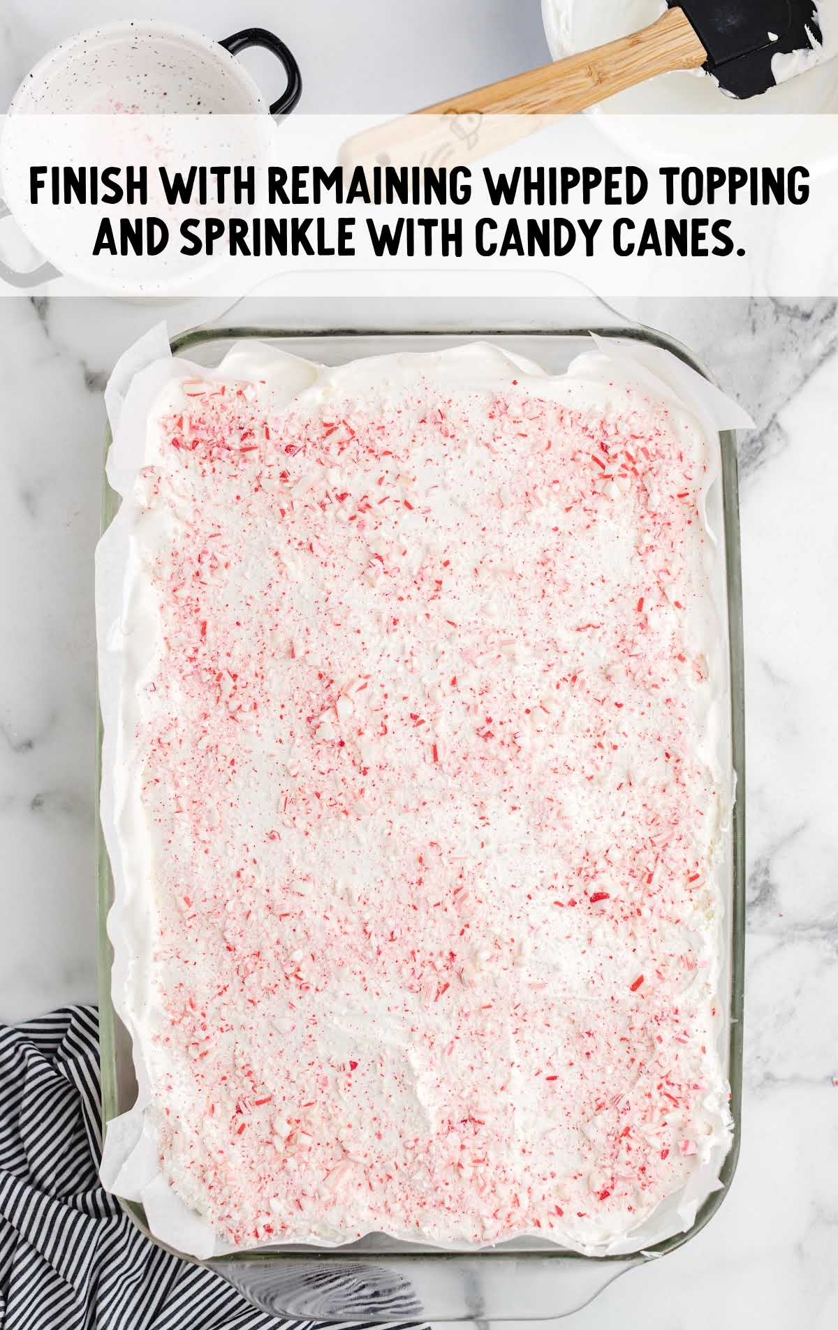 whipped topping and candy canes topped on top of the dessert