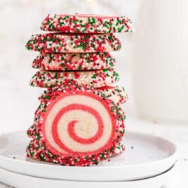 christmas pinwheels cookies stacked on top of each other on a plate