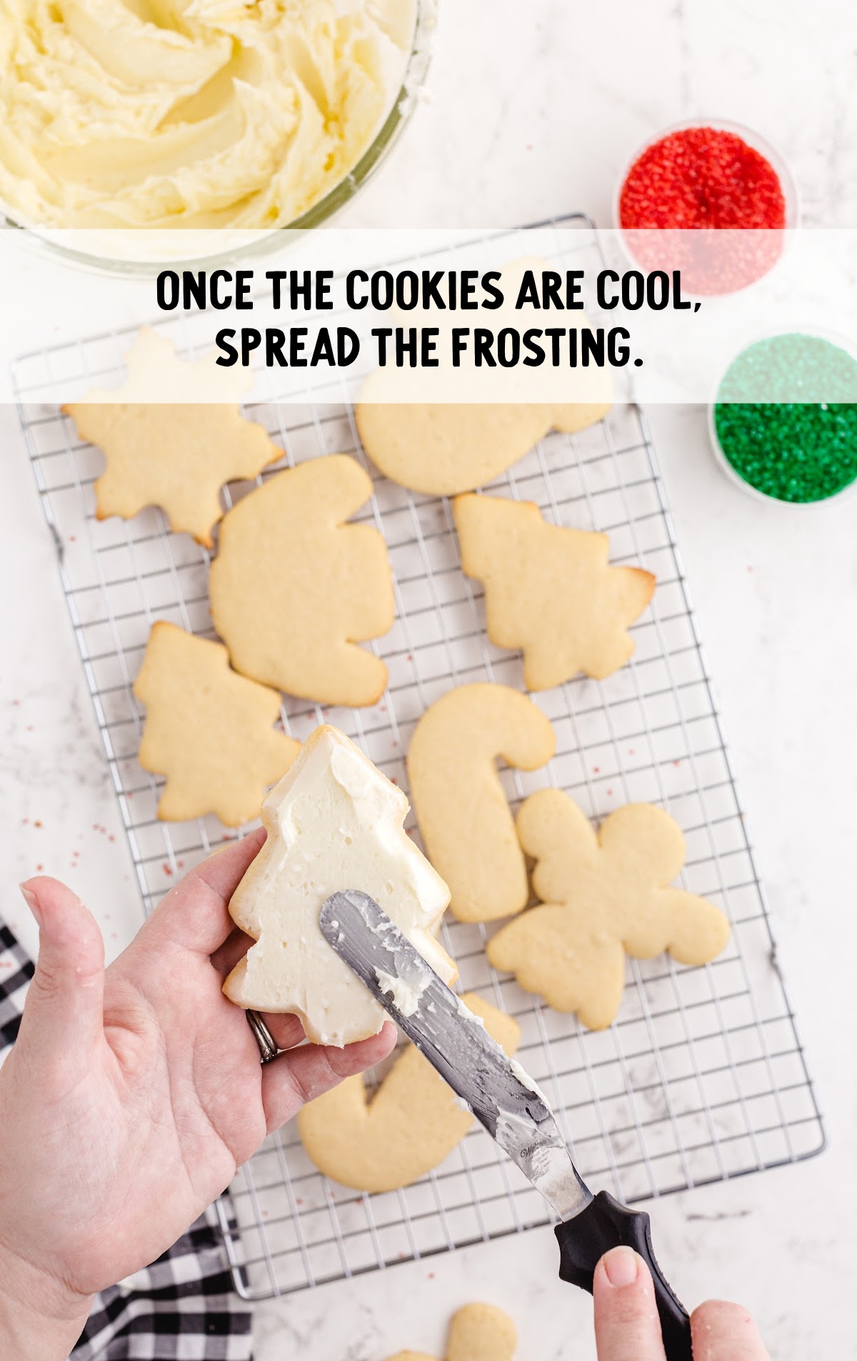 frosting spread on the cookie with a knife