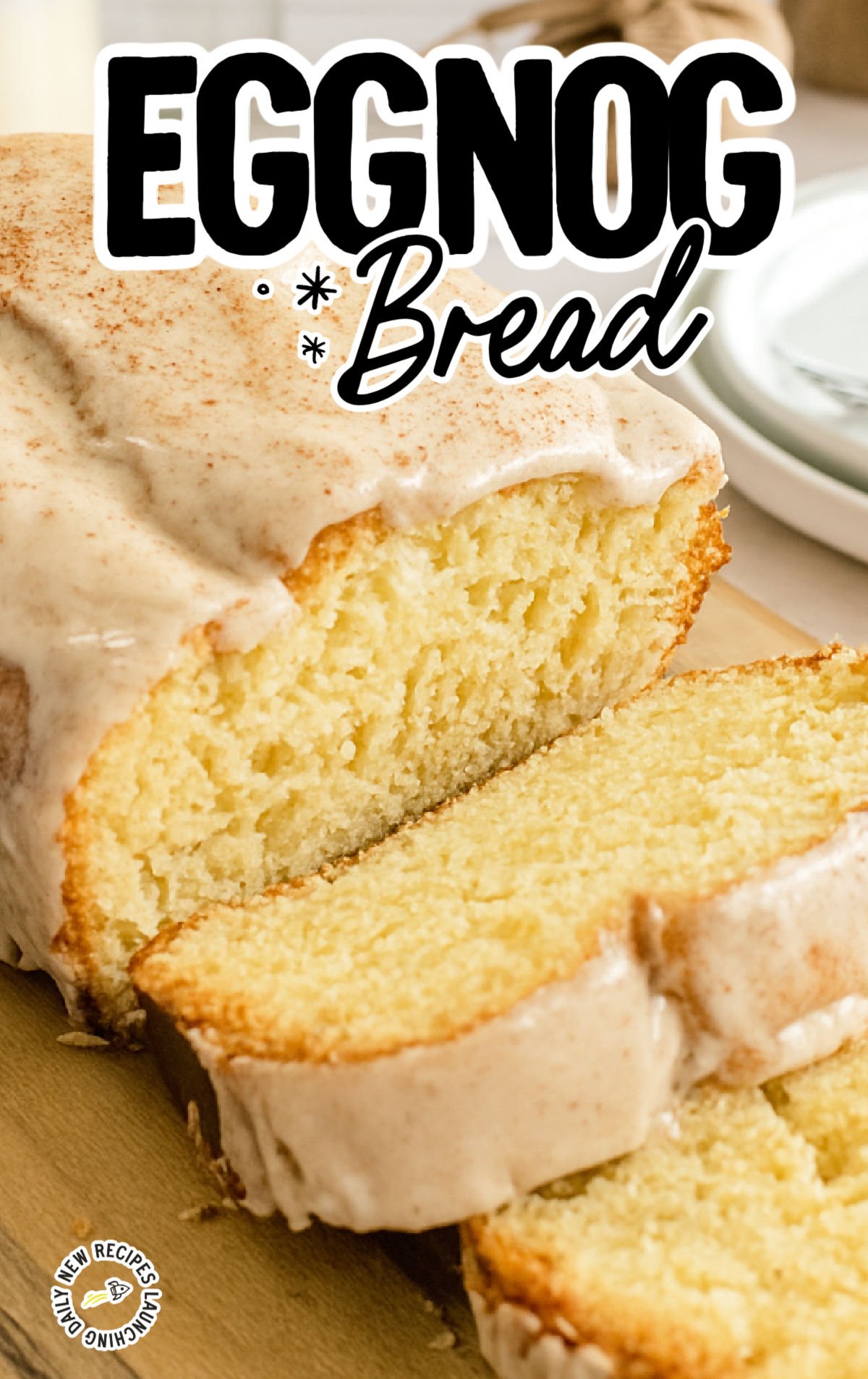 Sliced eggnog bread showing its moist, fluffy texture and thick nutmeg glaze.