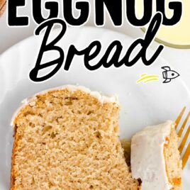 a close up shot of a sliced Eggnog Bread being cut by a fork