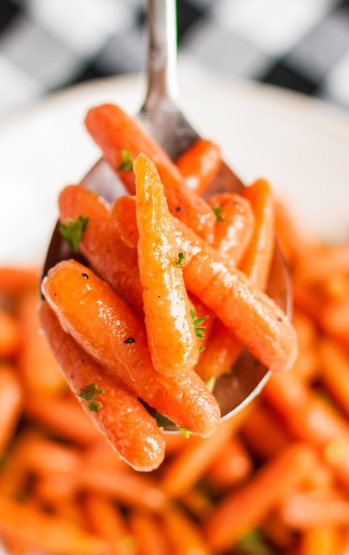 close up shot of glazed carrots in a spoon