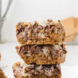 a close up shot of Magic Cookie Bars stacked on top of each other