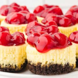 close up shot of mini cherry cheesecakes on a serving trey