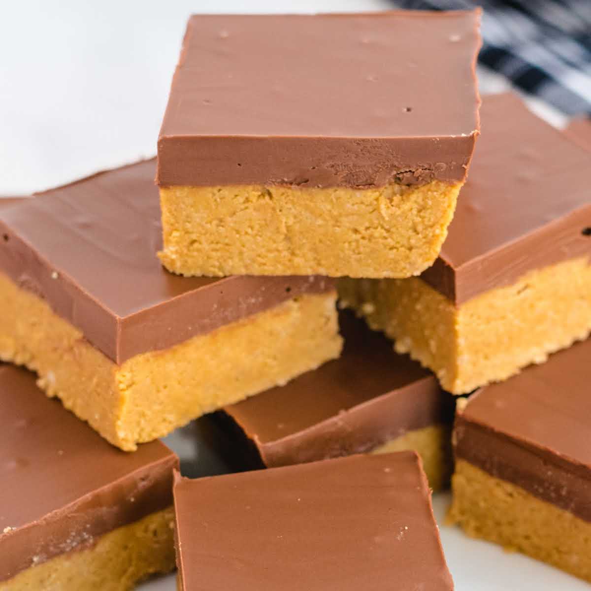 close up shot of No-Bake Peanut Butter Bars stacked on top of each other