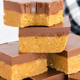 close up shot of No-Bake Peanut Butter Bars stacked on top of each other