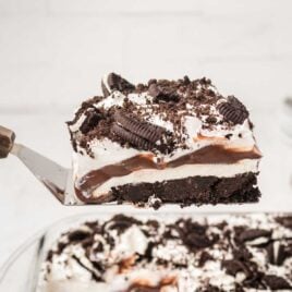 a close up shot of a slice of Oreo delight being picked up with a spatula