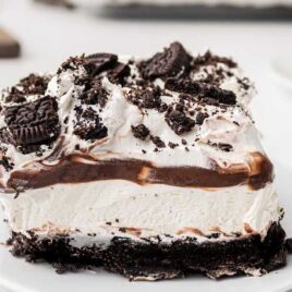 close up shot of a slice of Oreo delight on a white plate