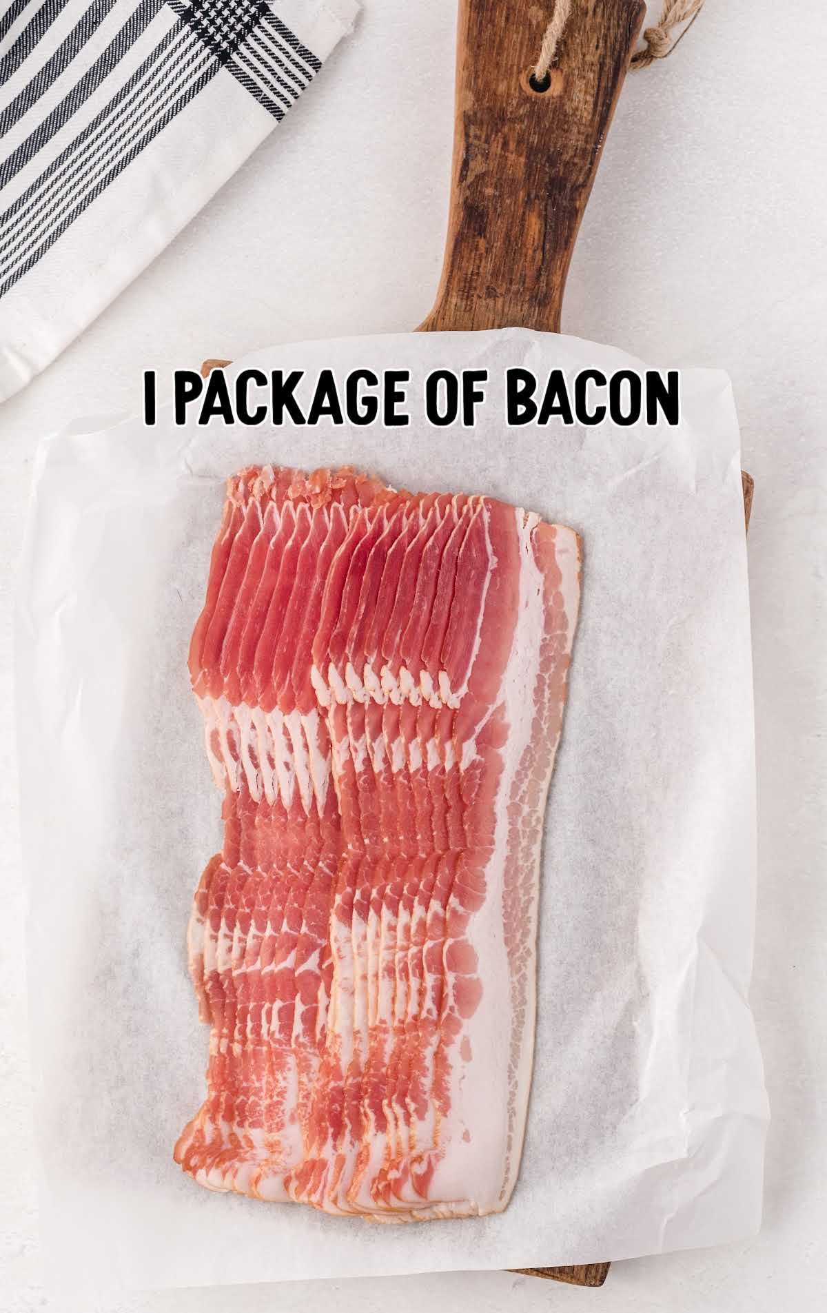 ackage of raw bacon laid out on parchment paper over a wooden cutting board.