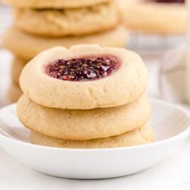 close up shot of a bowl of Thumbprint Cookies stacked on top of each other