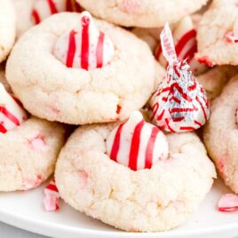 close up shot of a plate of candy cane kiss cookies