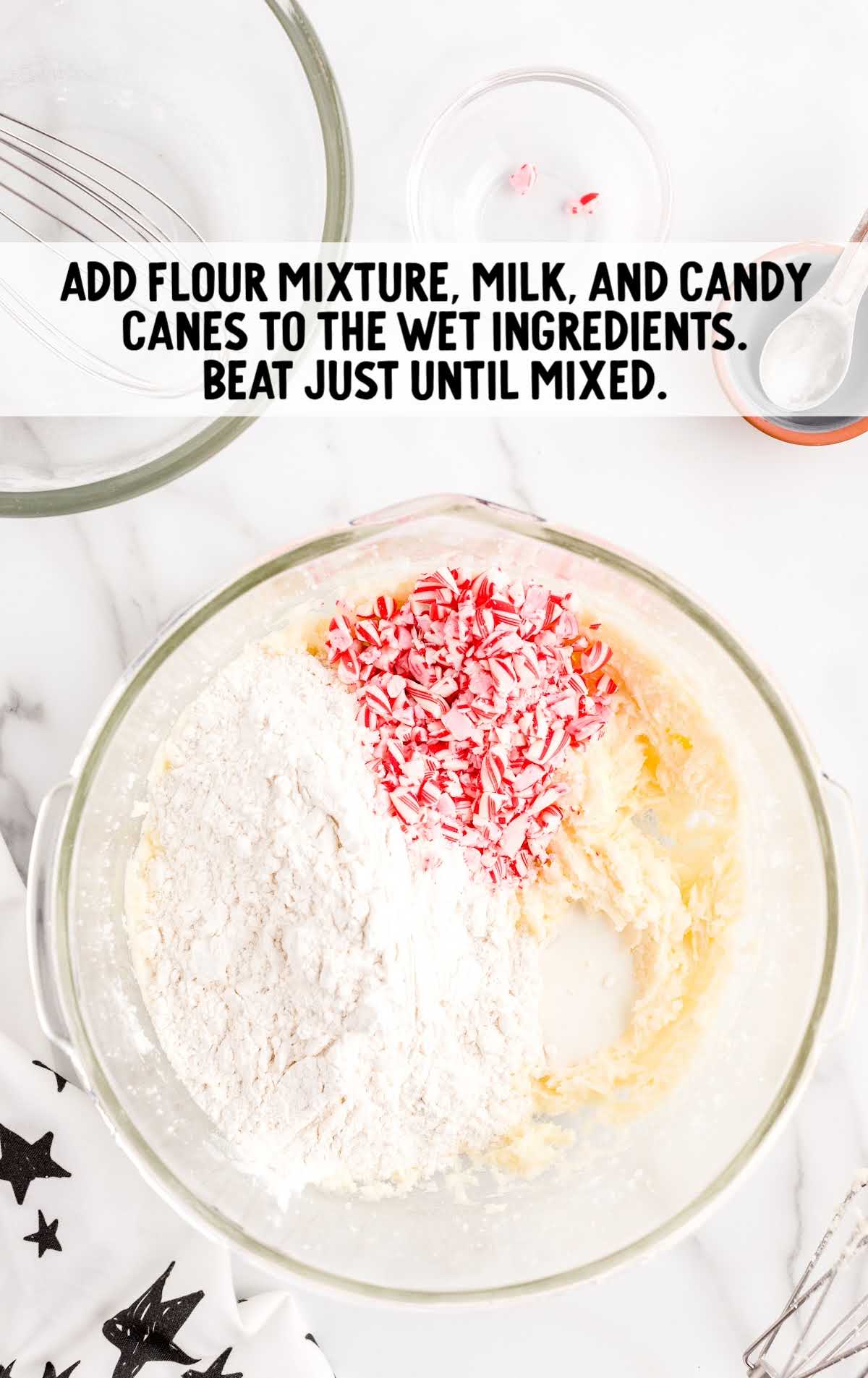 flour mixture, milk, and candy canes added to the wet ingredients in a bowl