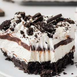 close up shot of a slice of Oreo delight on a white plate