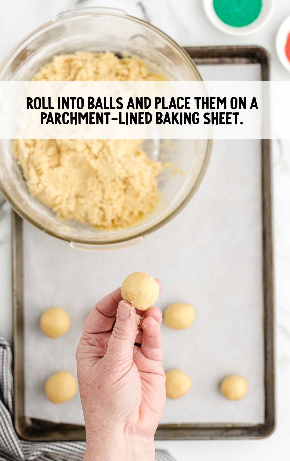 cookie dough rolled into balls and placed on a sheet
