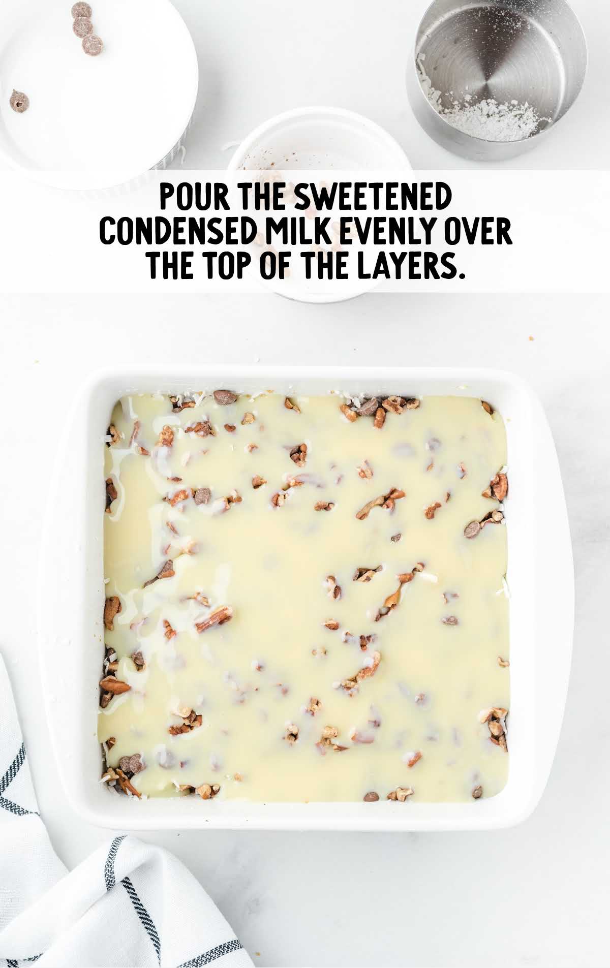sweetened condensed milk poured over the top layer in a baking dish