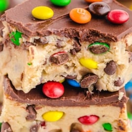 Stack of no-bake cookie dough bars topped with M&M's and chocolate, labeled as the viral recipe.