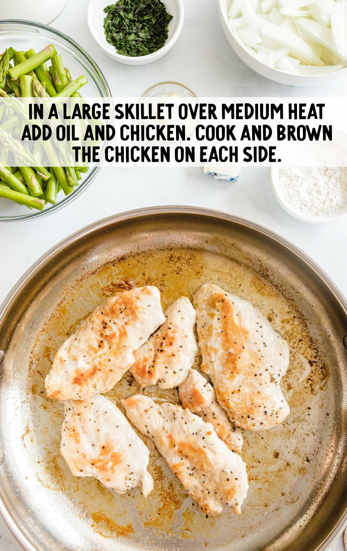 creamy chicken and asparagus cooked on a skillet