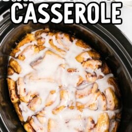 close up overhead shot of Crockpot Cinnamon Roll Casserole in a crockpot topped with icing