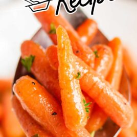 close up shot of a spoonful of Glazed Carrots garnished with parsley
