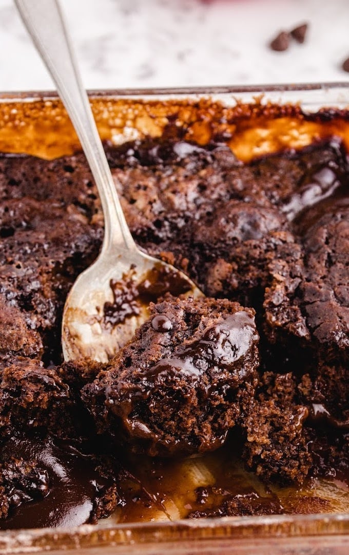 close up shot of hot fudge sundae cake in a clear baking pan