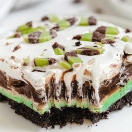 close up shot of Mint Chip Dessert Lasagna on a plate with a slice taken out of it with a fork