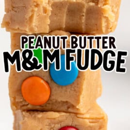 Three creamy peanut butter fudge squares stacked, each topped with colorful M&M candies. Text across the image reads Peanut Butter M&M Fudge with Vintage Peanut Butter Fudge (Microwave) Recipe! in the bottom right corner.