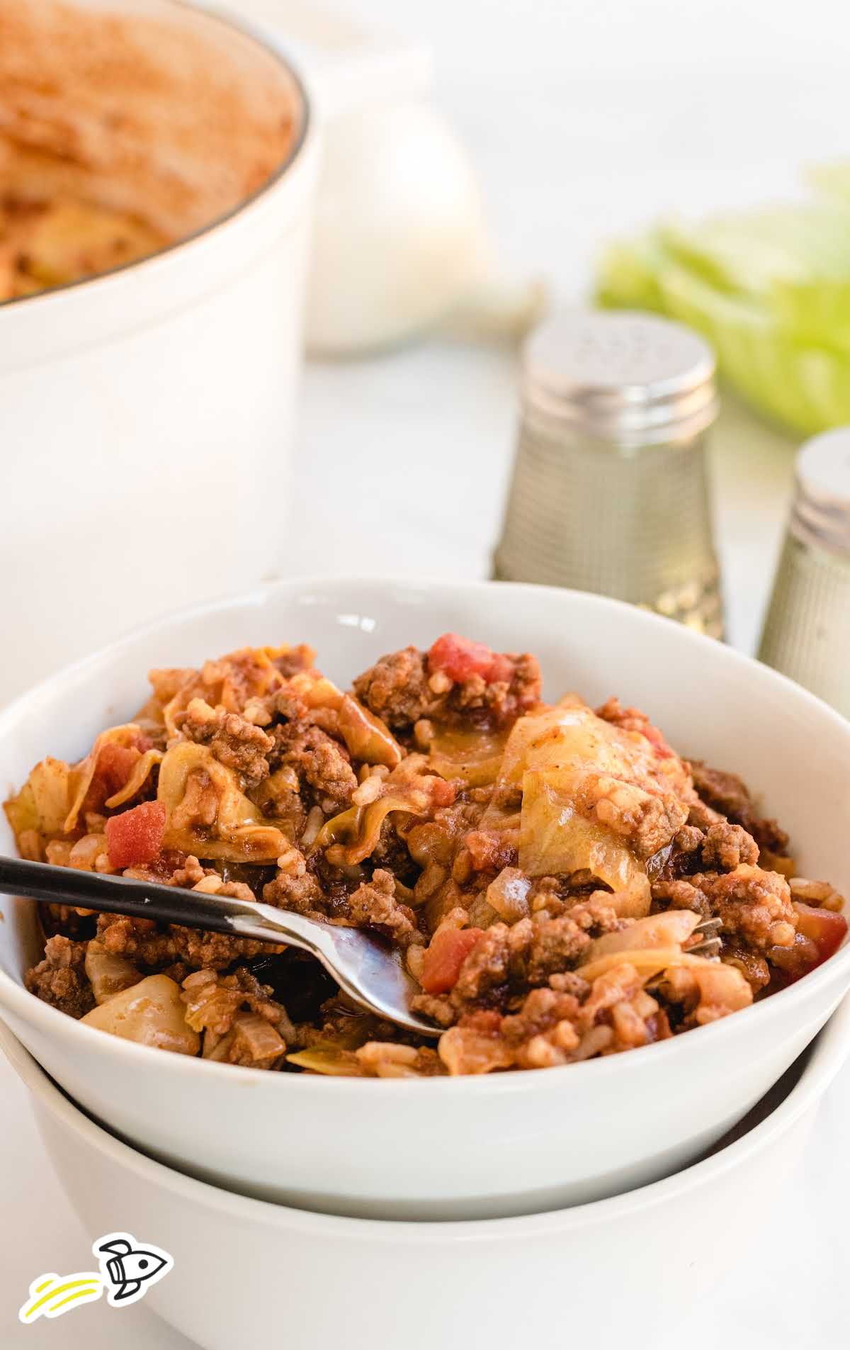 a bowl of unstuffed cabbage rolls with a spoon