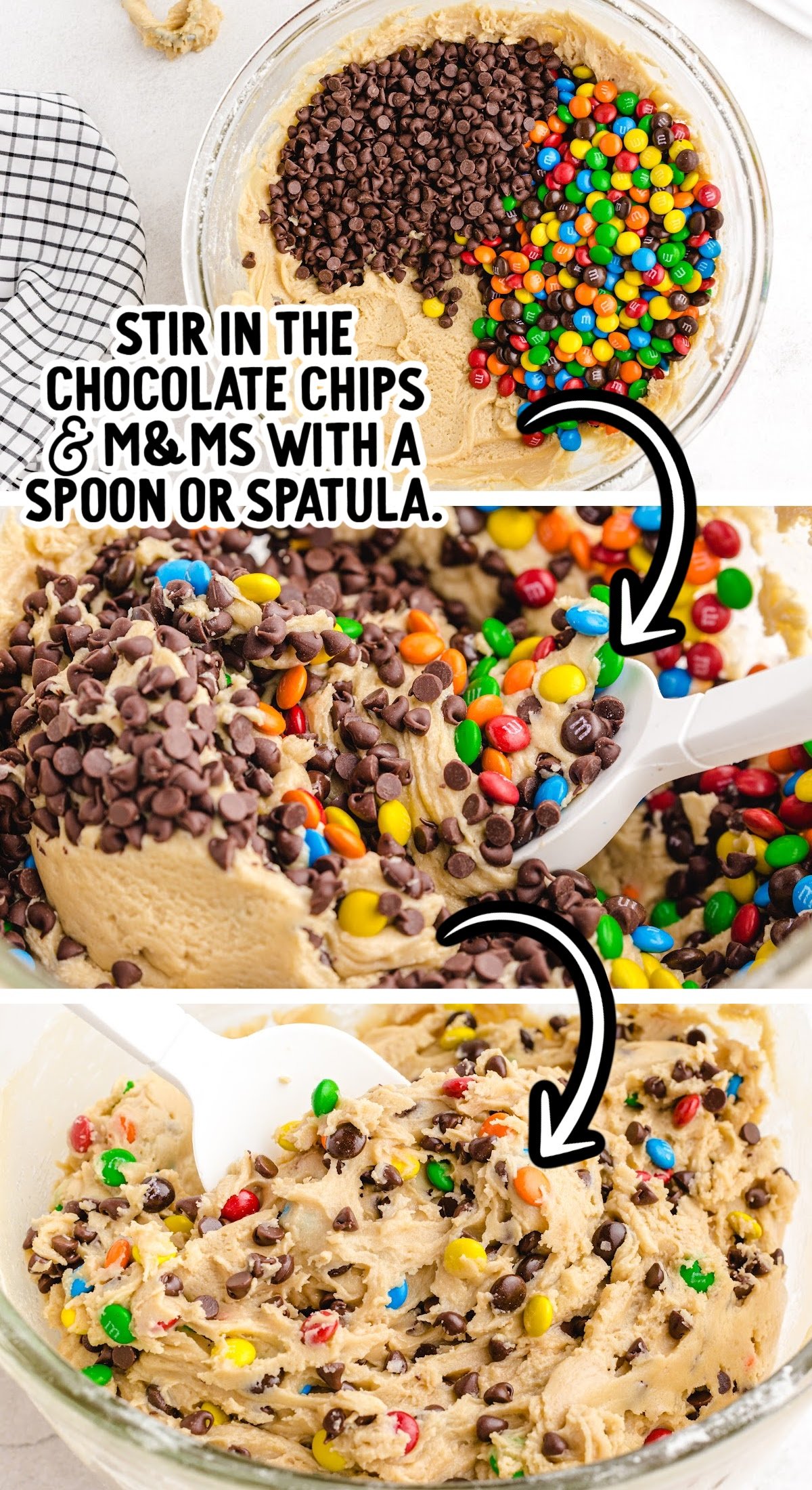 Overhead view of cookie dough batter being stirred with mini chocolate chips and M&M's using a white spatula.