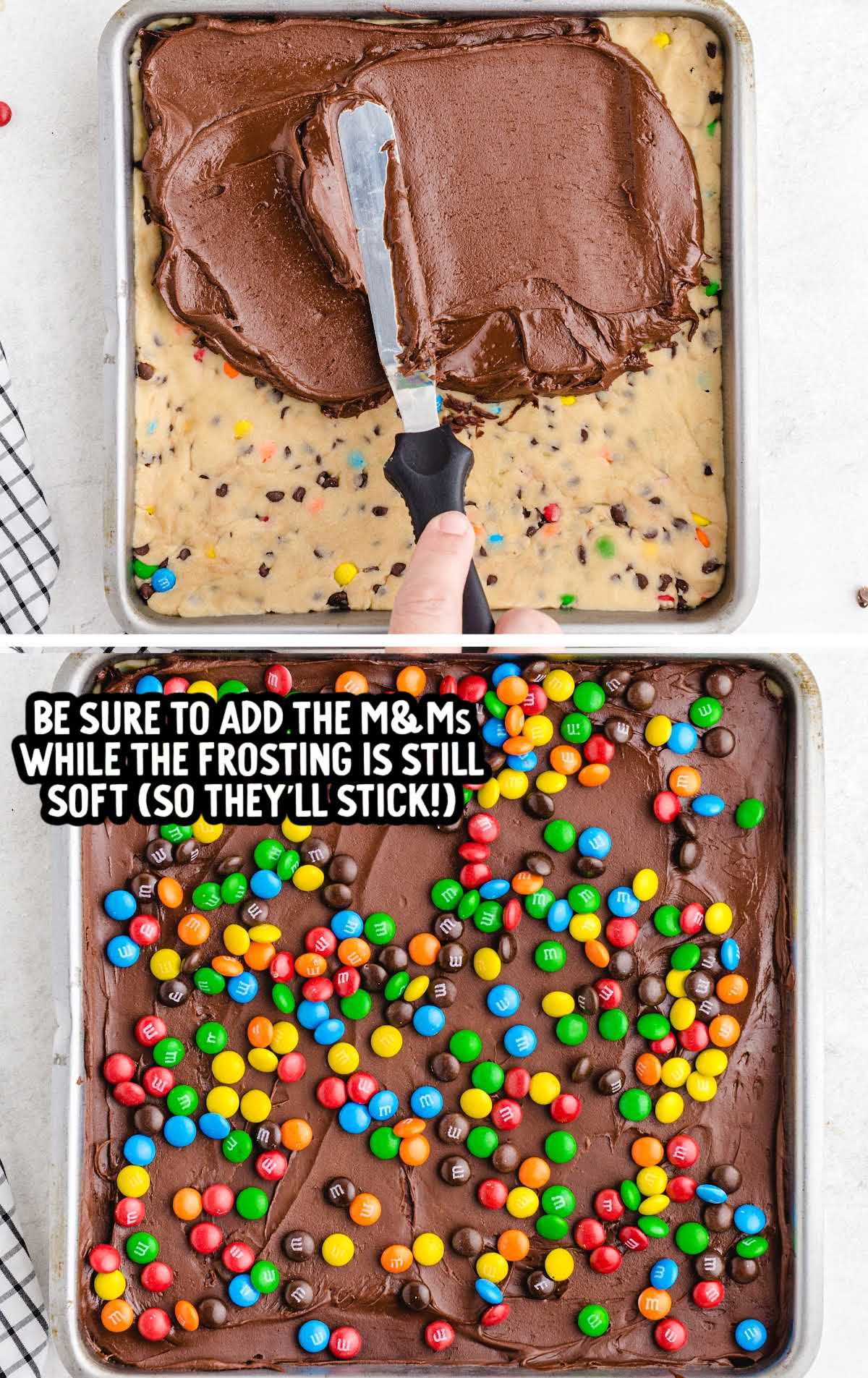 Spreading chocolate frosting over cookie dough bars in a baking pan, followed by sprinkling M&M's on top while the frosting is still soft.