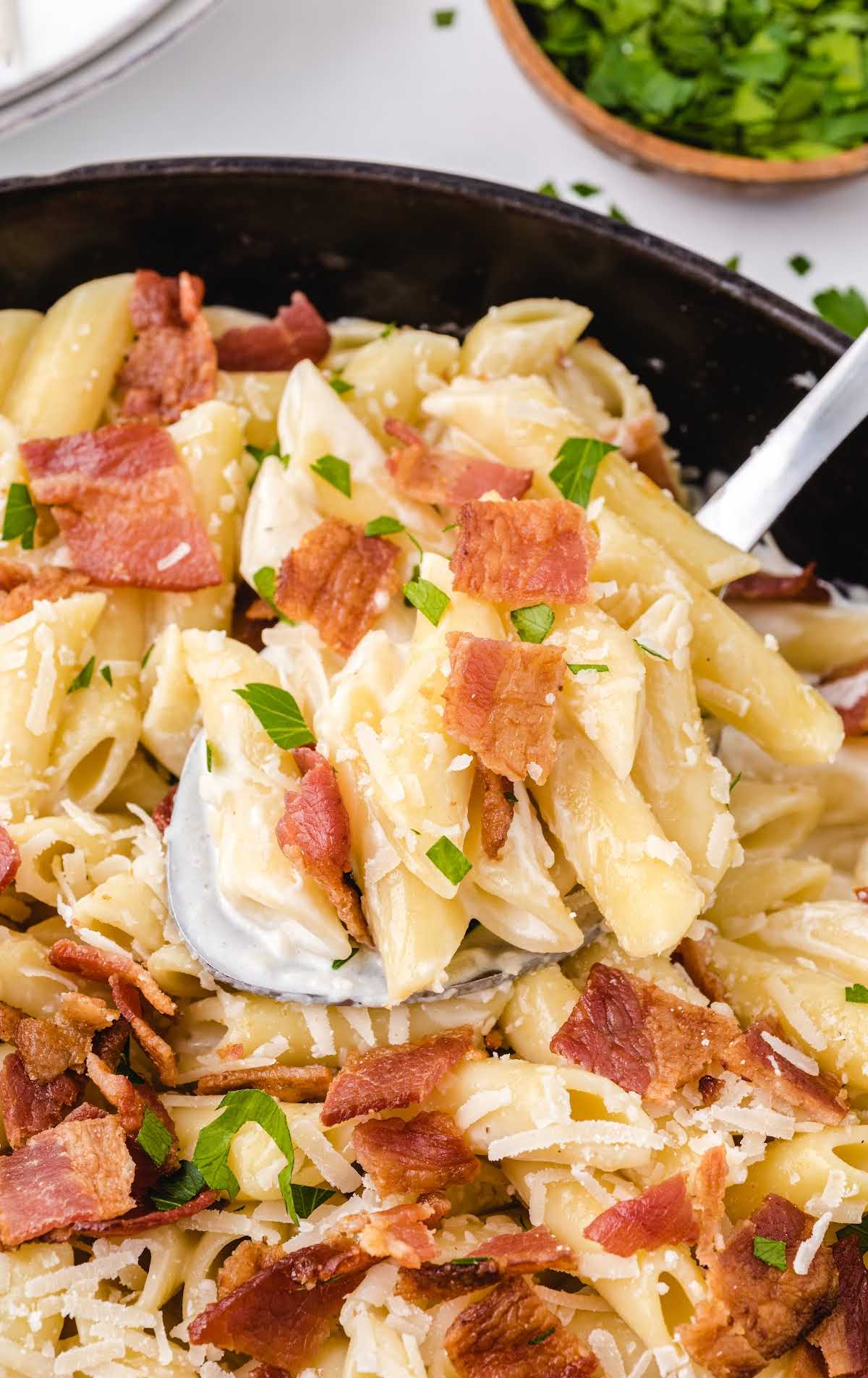close up shot of bacon pasta in a pan